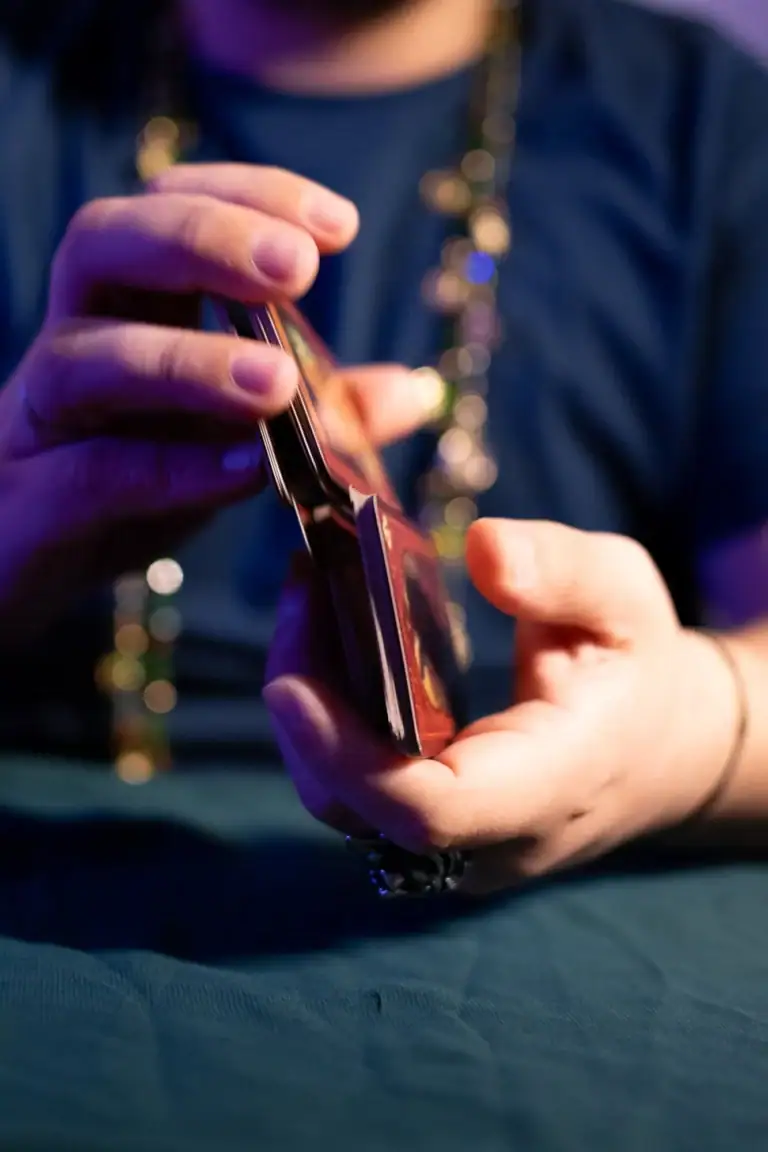 Pessoa segurando um smartphone com foco na mão e dispositivo.