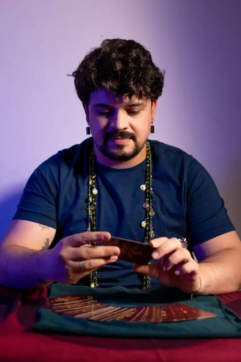 Fotógrafo Guilherme Marques com barba e cabelo cacheado usando camiseta azul.